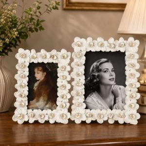 White flower frames with gold accents on a tabletop display